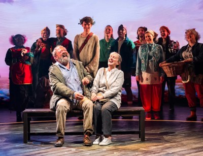 Mark Addy (Harold Fry), Noah Mullins (the Balladeer) and Jenna Russell (Maureen Fry), © Tristram Kenton. Review of The Unlikely Pilgrimage of Harold Fry at Theatre Royal Haymarket, London, 2026